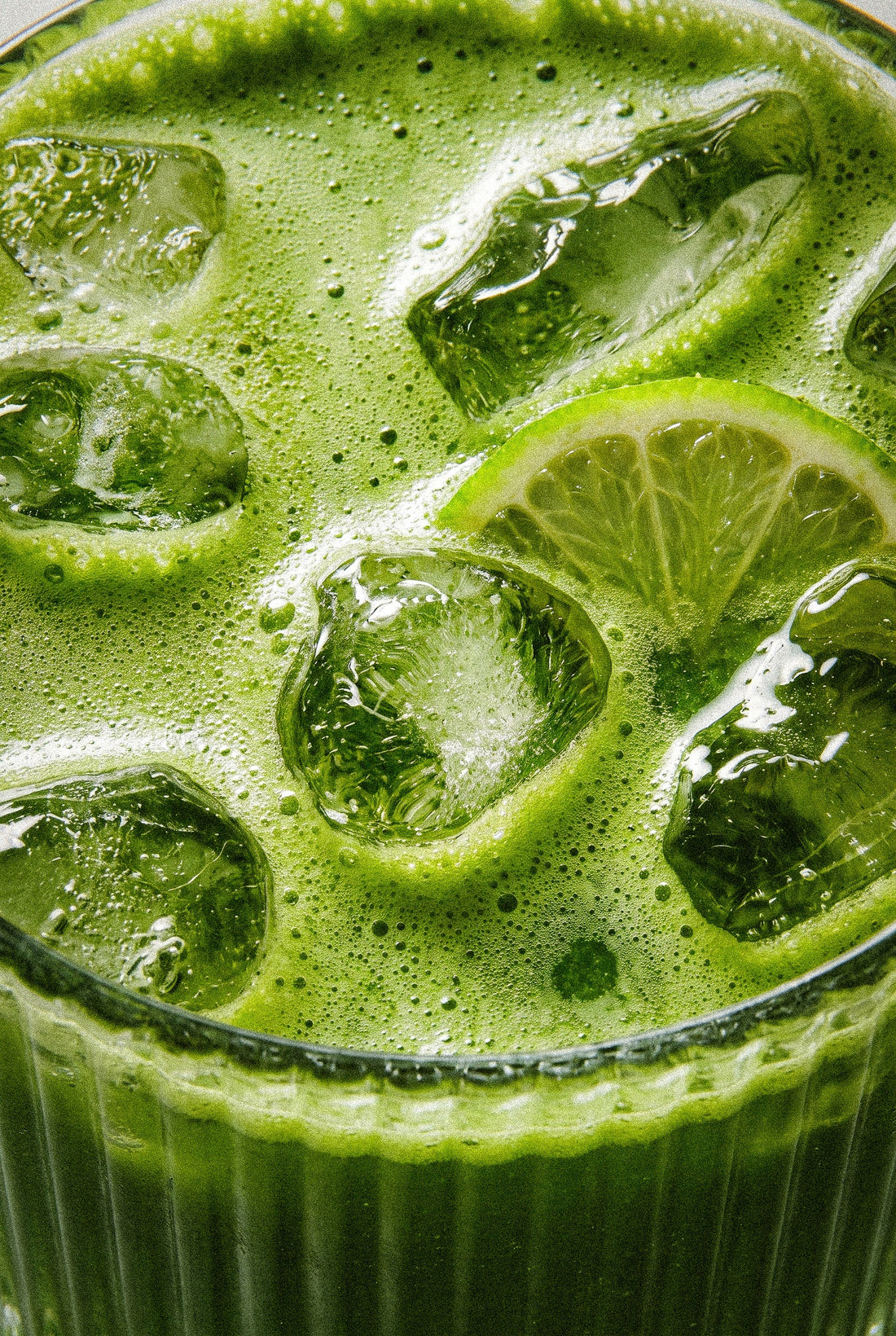 An iced KaMoss matcha latte with ice and lime